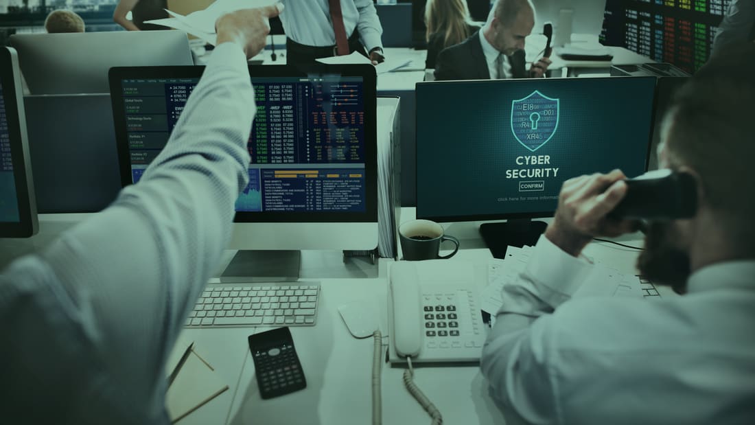 A professional team at work beside a security console